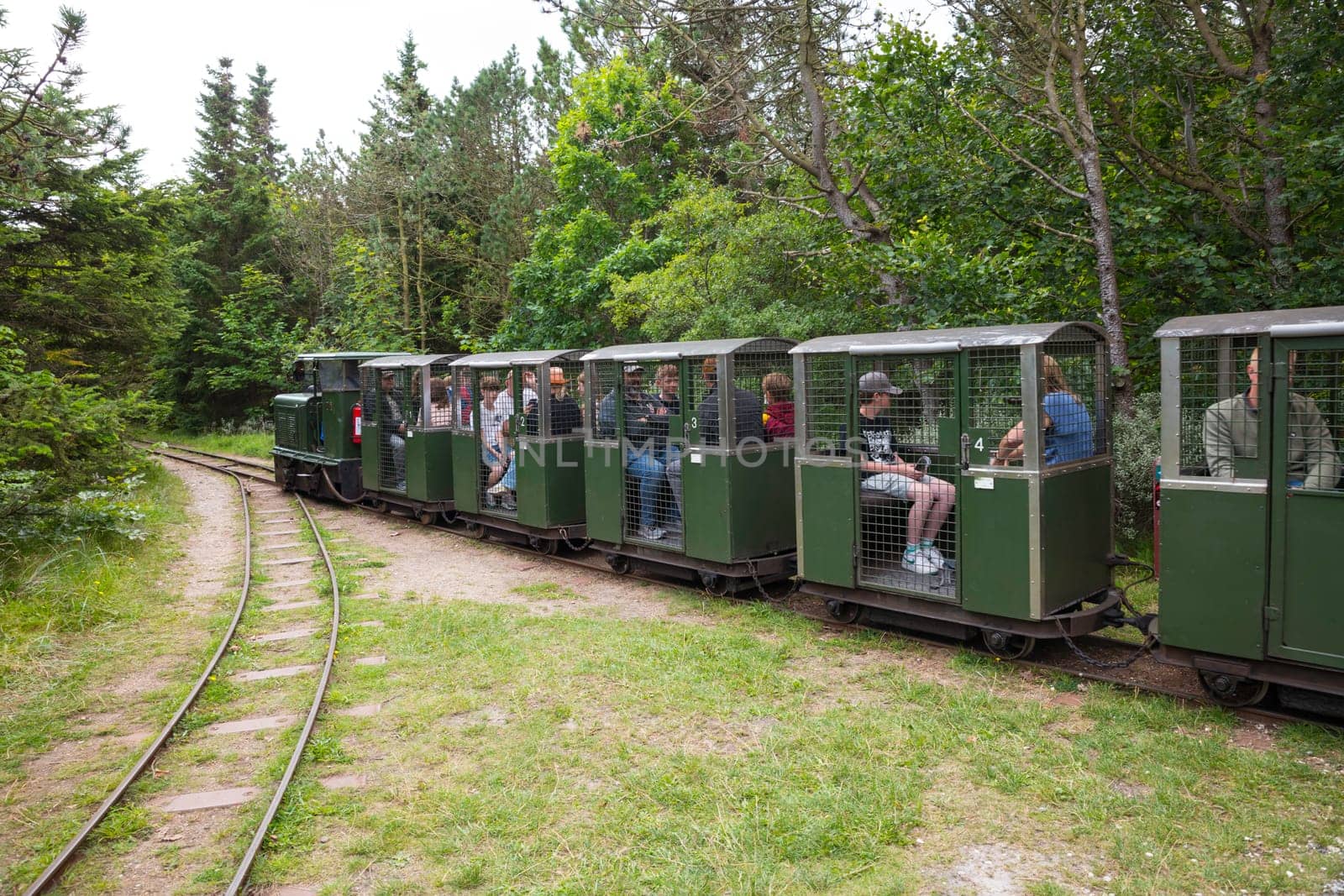 hansholm,denmark,18-08-2024:people enjoy a ride on the old ammunition train in hansholm denmakr, the ammunition used in the 38 cm guns was too heavy to be simply carted around on a handcart.