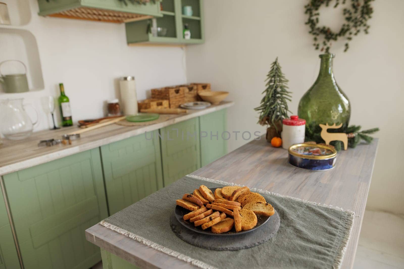 Scandinavian style kitchen decorated in Christmas style, there is a plate of cookies on the table, decor