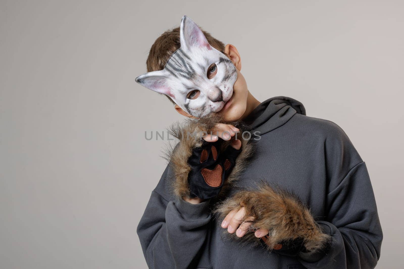 portrait of a teenager quadrobics in a cat mask on a white background, quadrobika subculture imitation of animal actions