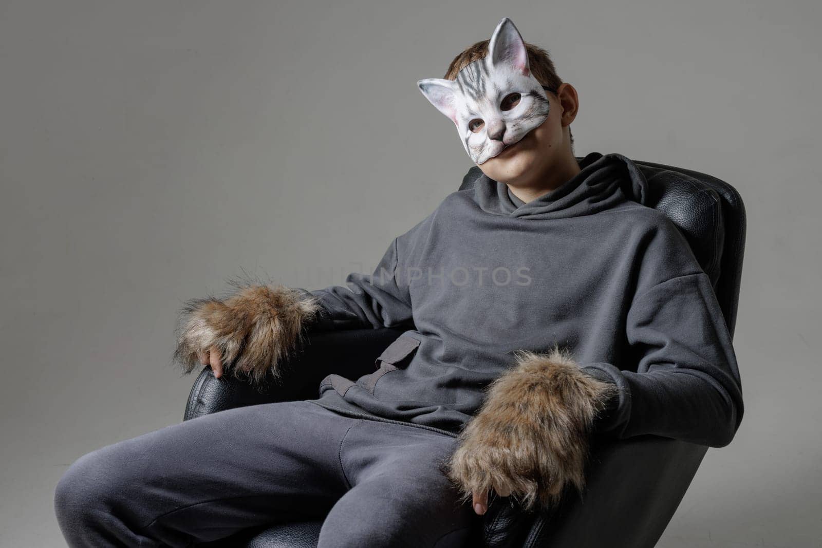 portrait of a teenager quadrobics in a cat mask on a white background, quadrobika subculture imitation of animal actions