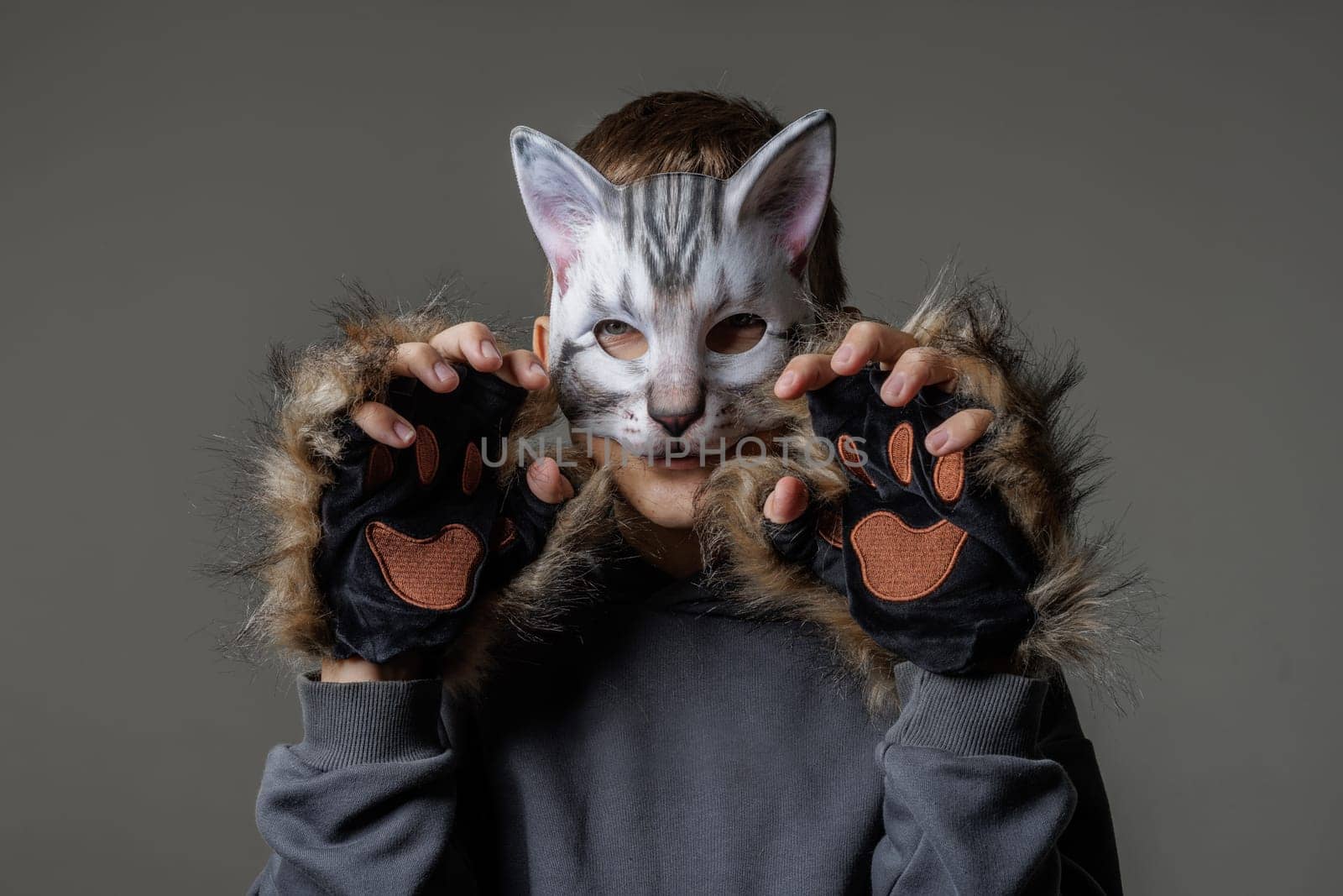 portrait of a teenager quadrobics in a cat mask on a white background, quadrobika subculture imitation of animal actions