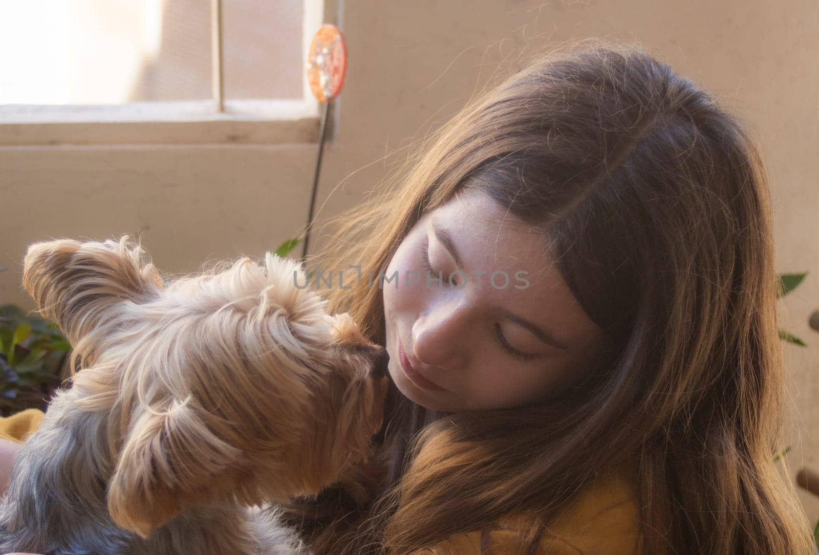 Horizontal picture of teenager enjoying a cute moment with her puppy outside. Free lifestyle concept. Moments of calm and happiness. Puppy lovers.Fun time concept