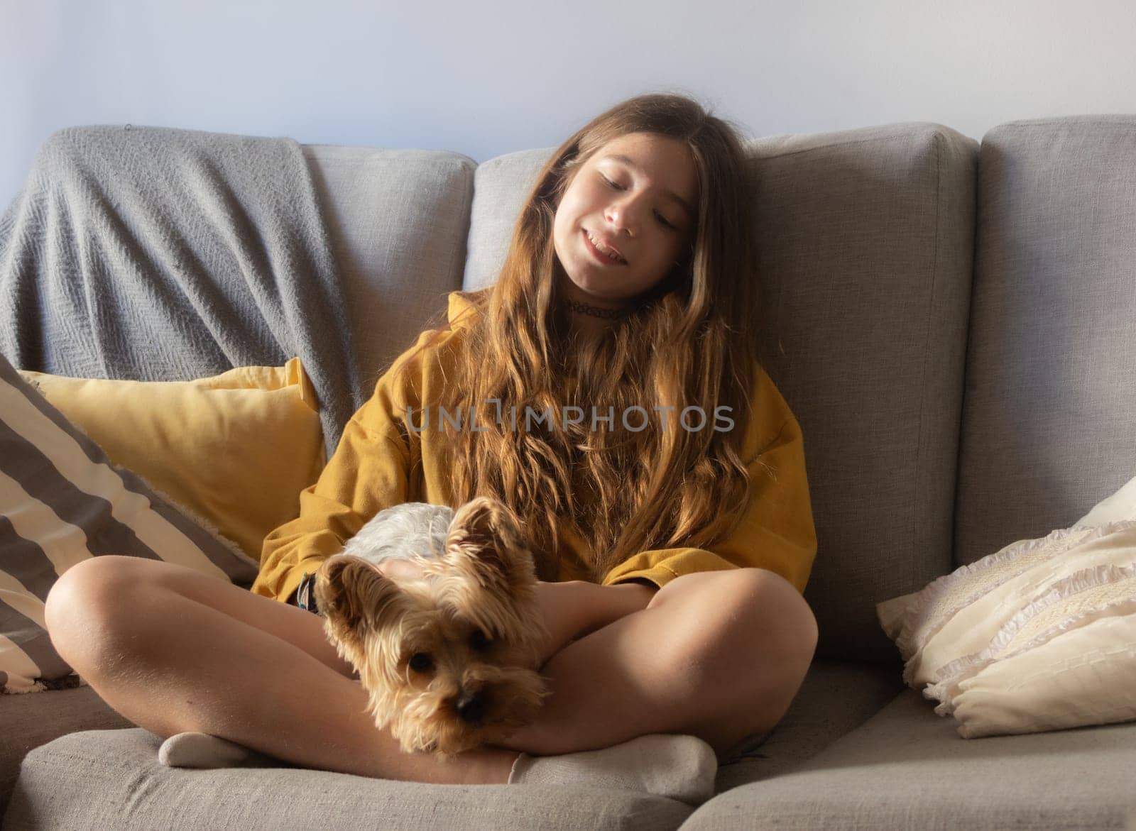 Horizontal photo of a cute girl enjoying with her pet and smiling. Free lifestyle concept. Moments of calm and happiness. Puppy lovers