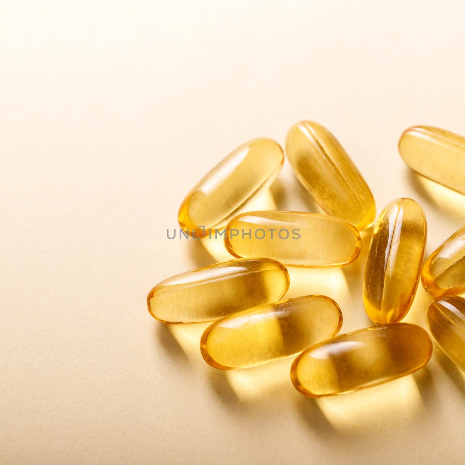 Fish oil capsules on beige background with copy space.