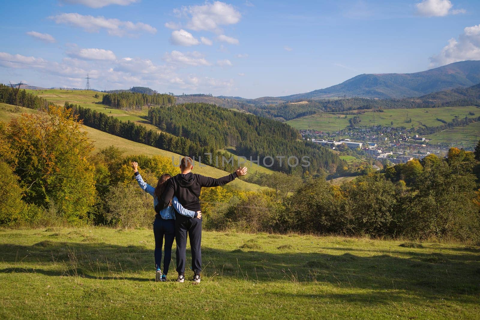 very beautiful panorama of the Carpathians in the autumn-a beautiful couple stands with their backs.