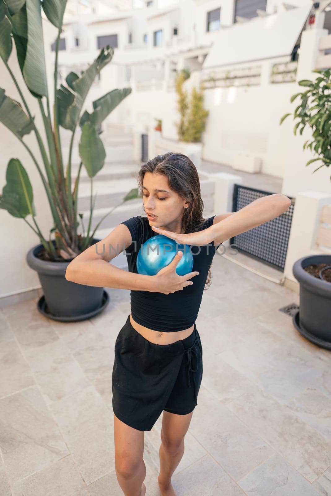 A skilled dancer elegantly engages with a globe, beautifully symbolizing global unity and vibrant creativity