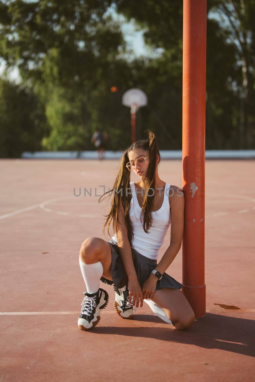 A dynamic and vibrant basketball court moment showcasing a young player performing in an athletic pose with energy