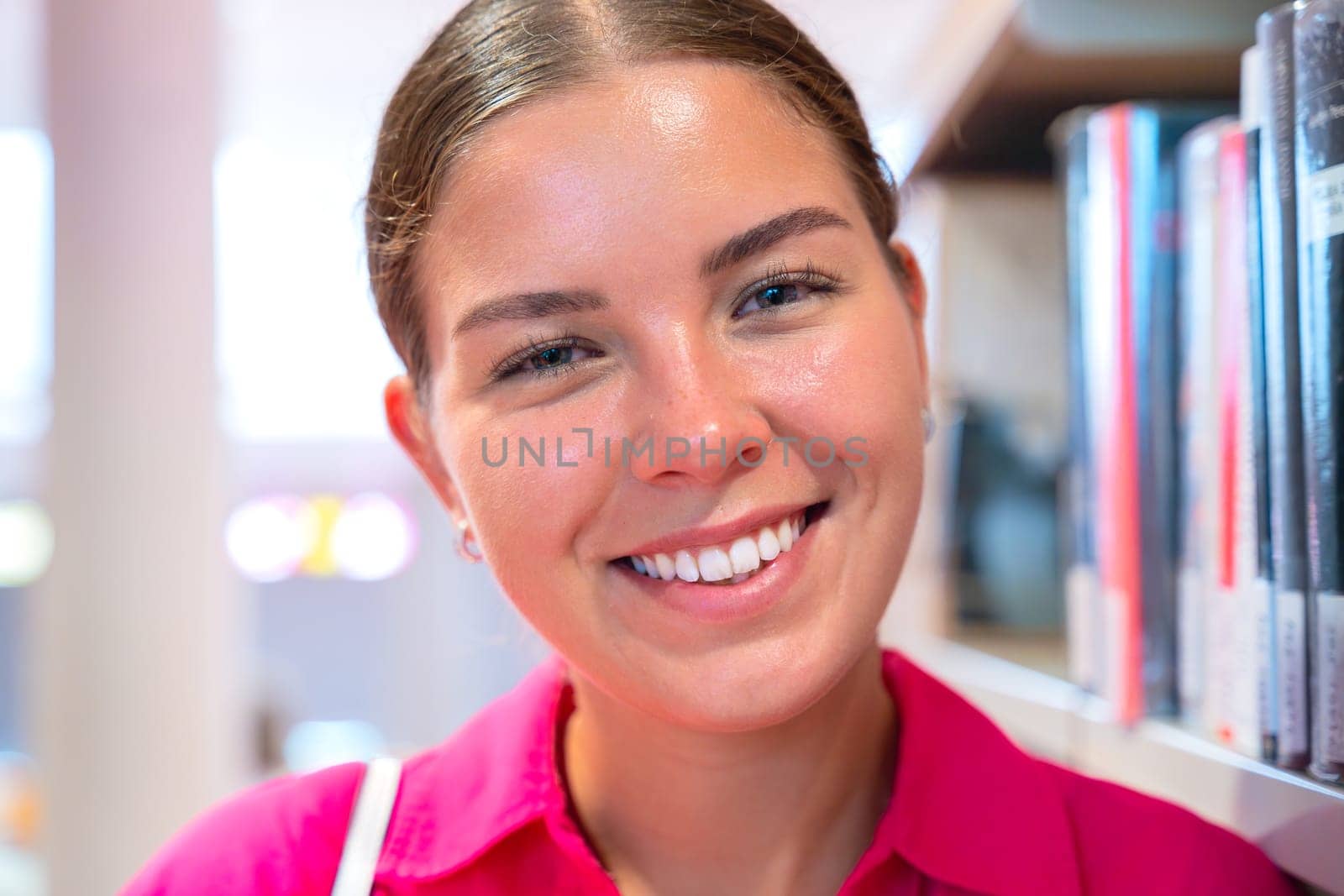 Beautiful russian teenage student laughing looking at camera outdoors. Girl sitting with happy face.