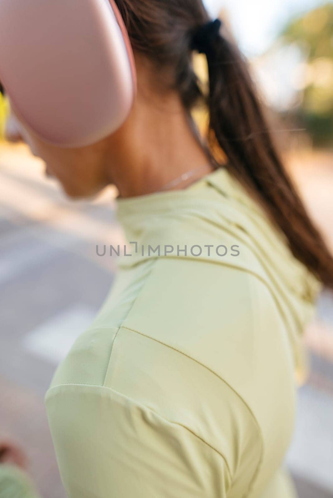 A person dressed in workout apparel and wearing headphones, clearly showcasing a vibrant and active lifestyle