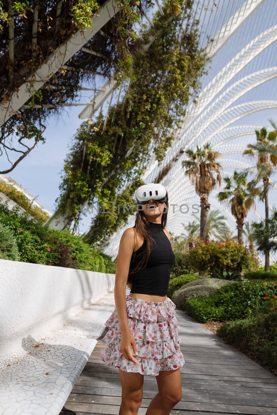 A fashionable roller skater poses amidst vibrant urban greenery, showcasing a blend of style and sport.