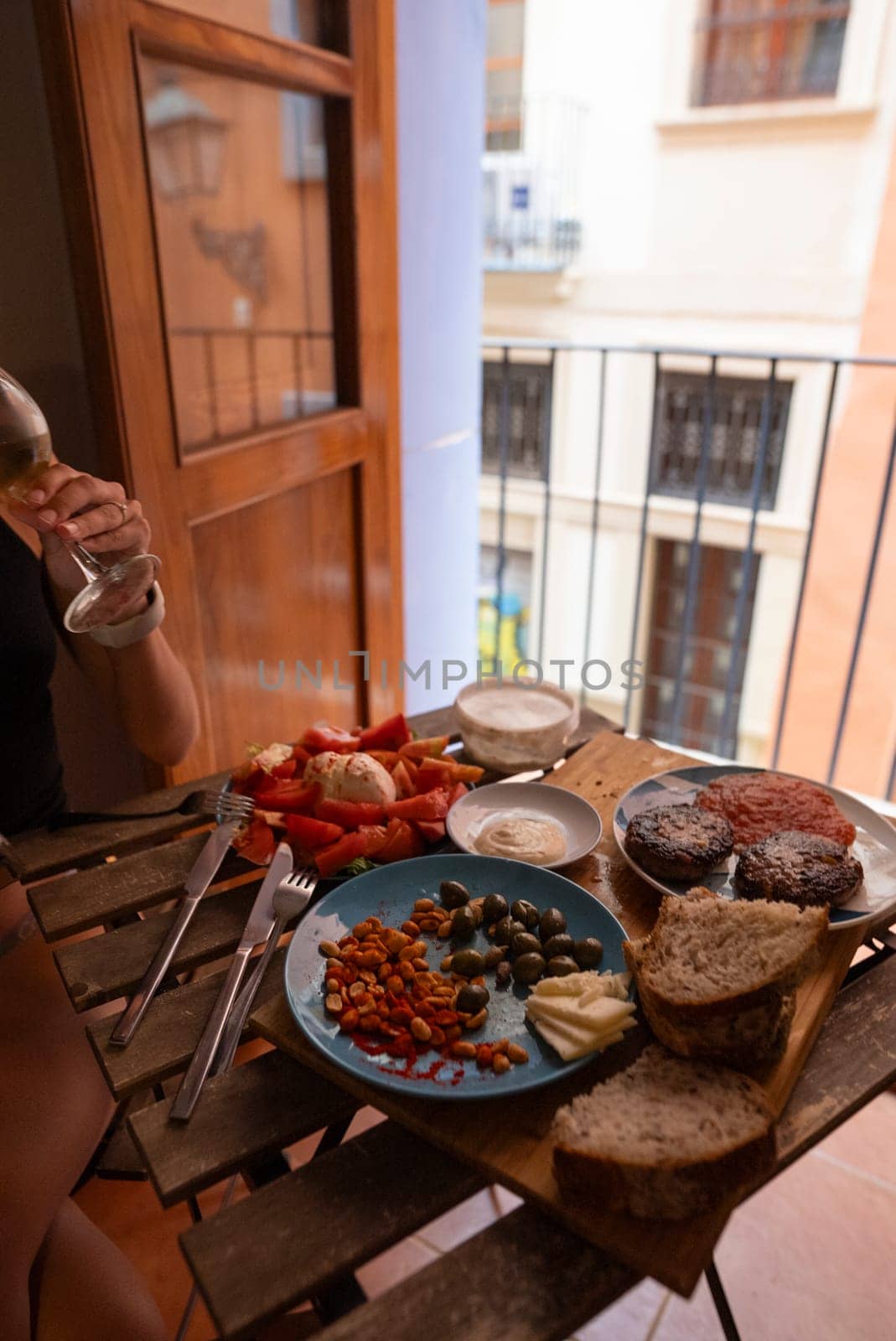 Relishing a vibrant and delightful meal outdoors on a beautiful, scenic balcony, featuring fresh, local dishes