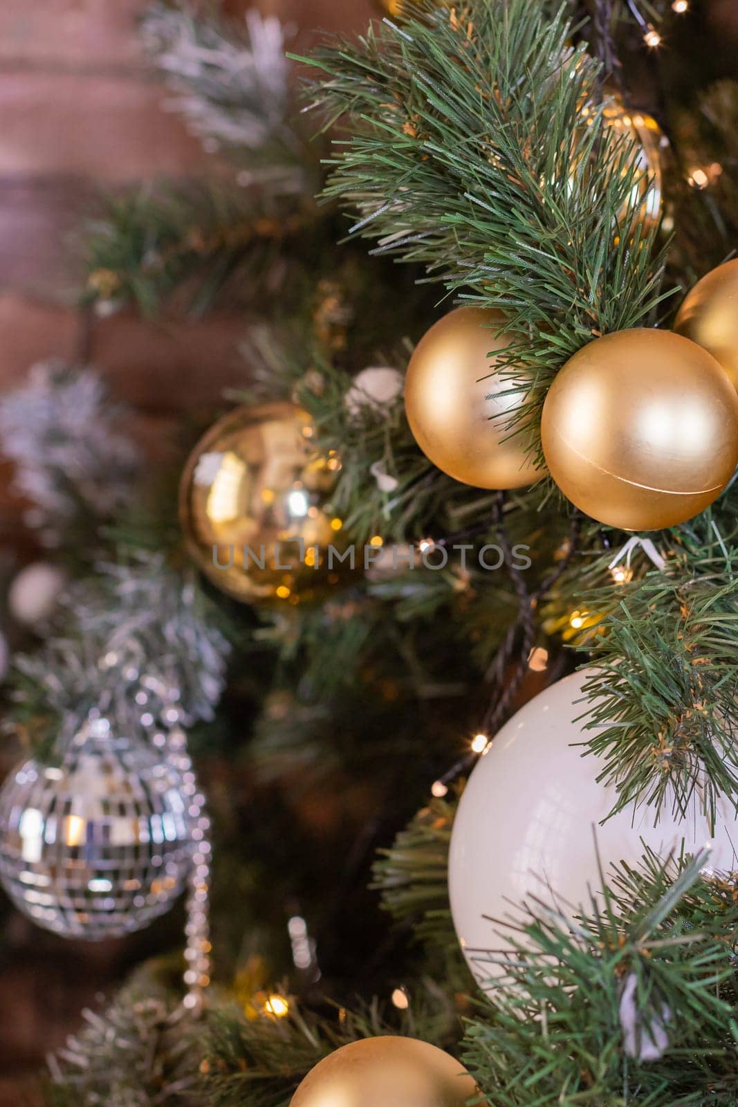 Christmas tree branches with decorations, balls, garlands, bokeh. Postcard with space for text.