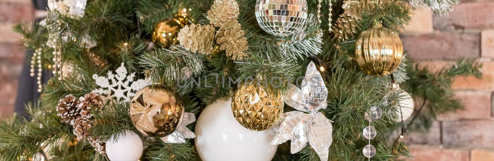 Christmas tree branches with decorations, balls, garlands, bokeh. Postcard with space for text.
