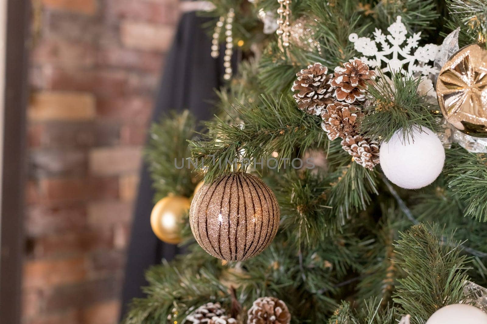 Christmas tree branches with decorations, balls, garlands, bokeh. Postcard with space for text.