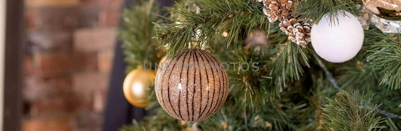 Christmas tree branches with decorations, balls, garlands, bokeh. Postcard with space for text.