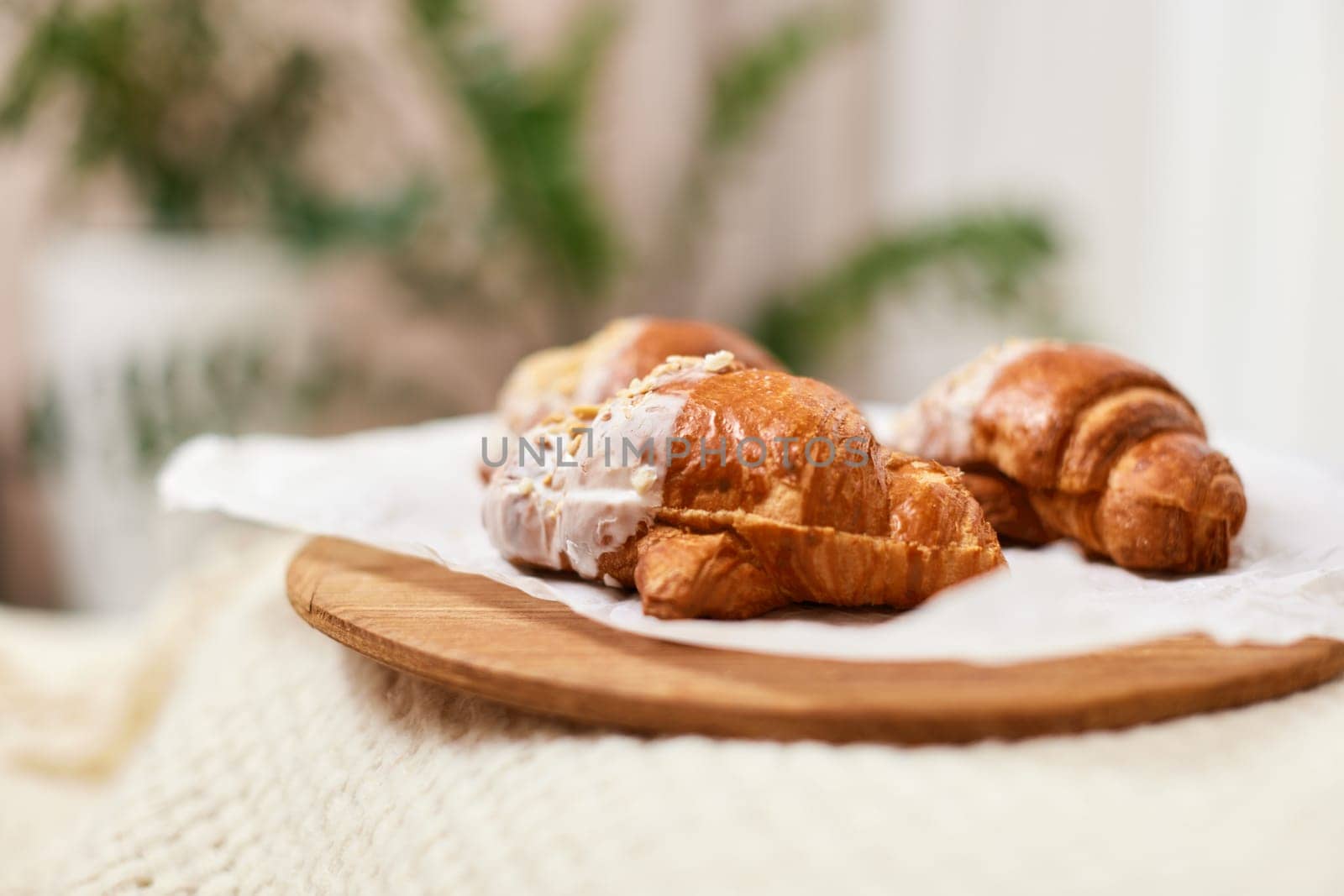 Delicious fresh french croissants on wooden tray for breakfast in bed in the morning, tasty breakfast