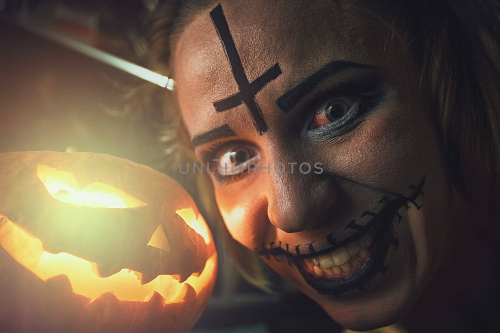 Horrible woman with scary mouth and eyes and pumpkin. Halloween holiday concept