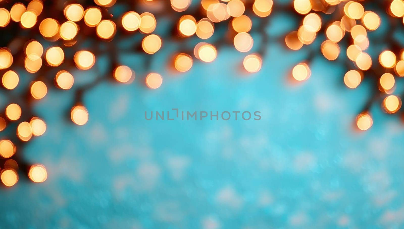 Abstract blurred Christmas lights on a turquoise blue background with copy space.