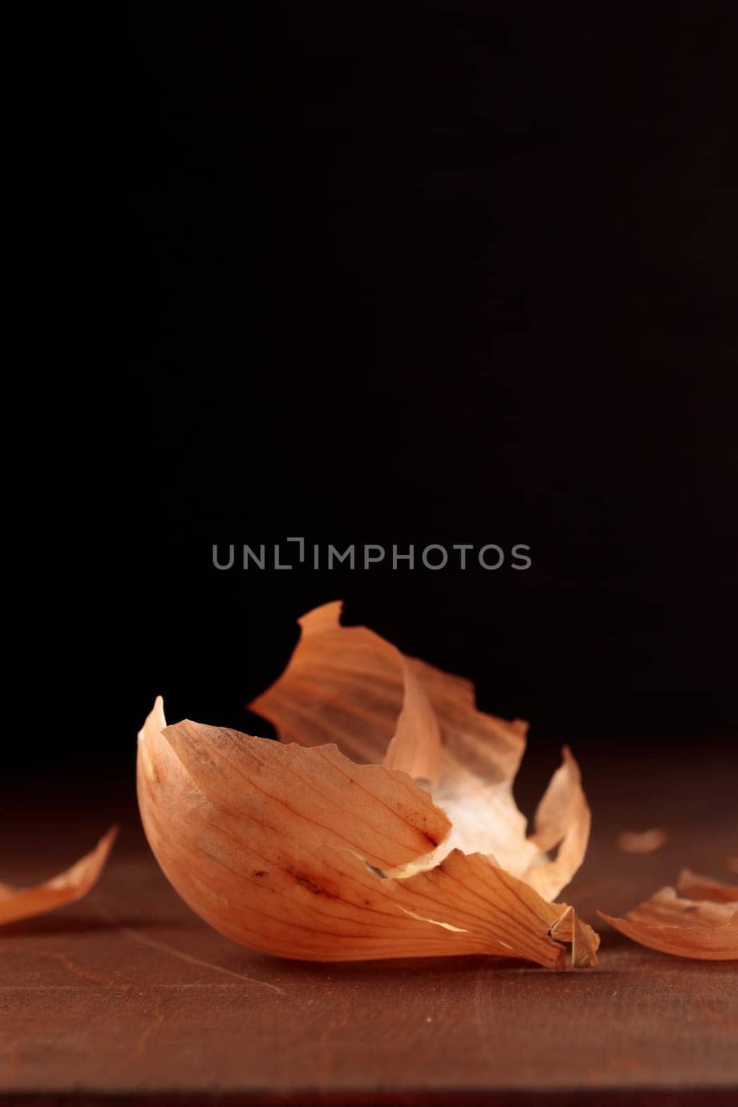 Golden onion's husk, yellow peel on a table on a dark background
