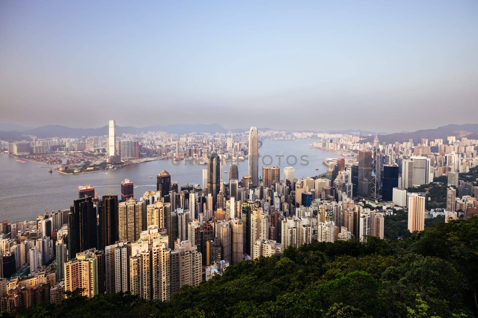 HONG KONG, CHINA - SEPTEMBER 29, 2024: Iconic view around sunset from Lugard Rd Lookout which overlooks Hong Kong Island and Kowloon in Hong Kong, China