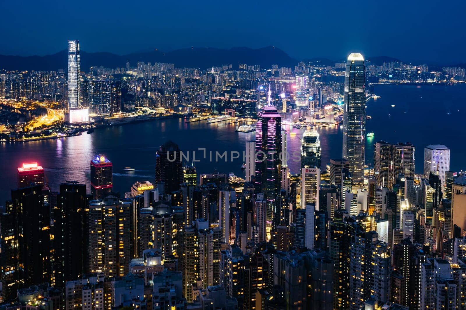 HONG KONG, CHINA - SEPTEMBER 29, 2024: Iconic view around sunset from Lugard Rd Lookout which overlooks Hong Kong Island and Kowloon in Hong Kong, China