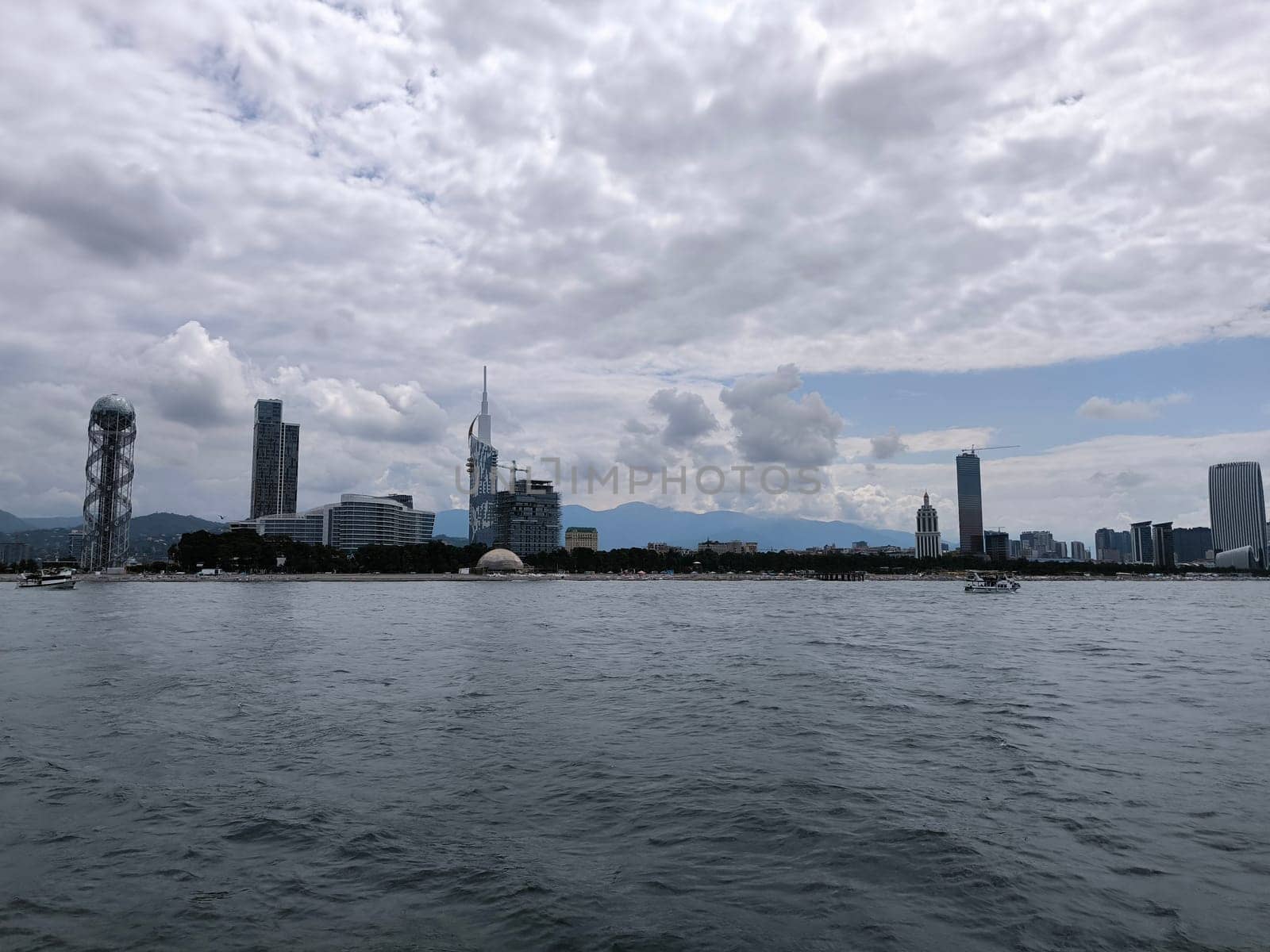 blue sea waves sky nature landscape water and white clouds. Batumi Georgia famous building beautiful evening city background. High quality photo