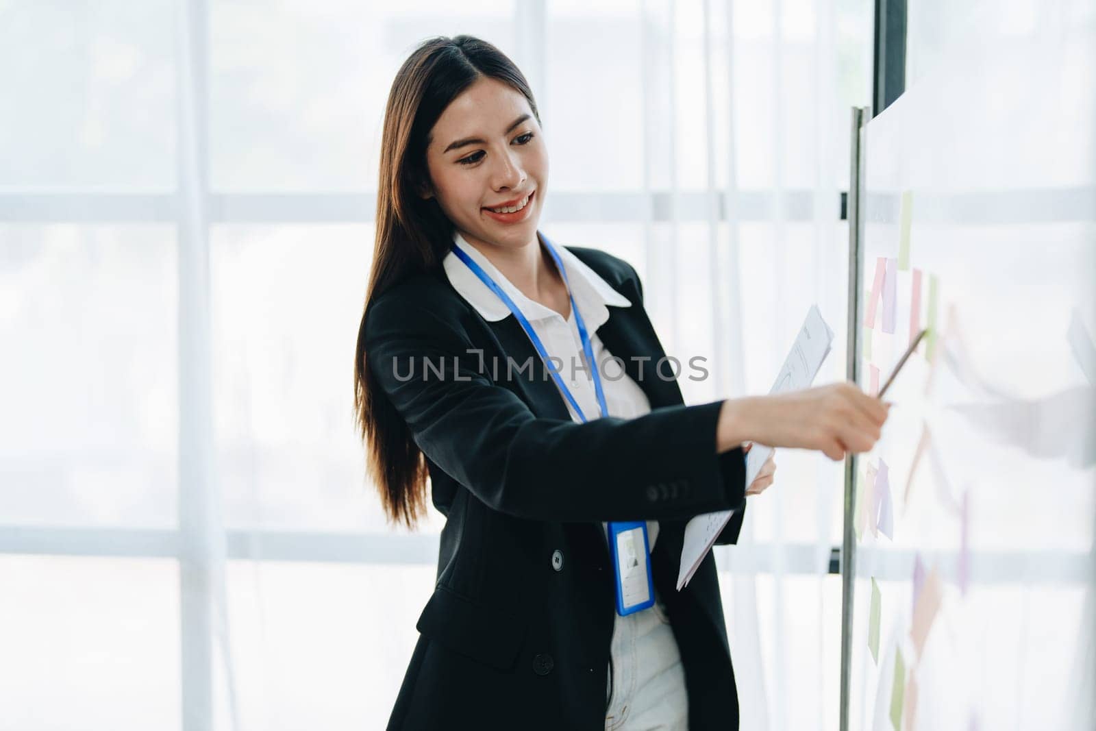 Beautiful young teen asian businesswoman using note pad thinking with planning working on financial document, tax, exchange, accounting and Financial advisor.