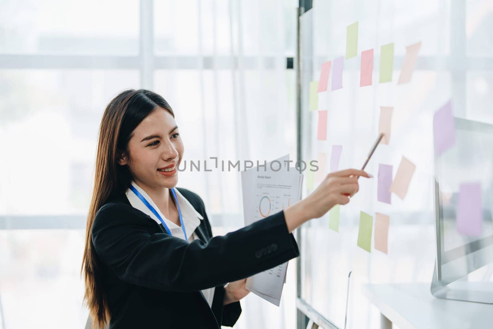 Beautiful young teen asian businesswoman using note pad thinking with planning working on financial document, tax, exchange, accounting and Financial advisor.