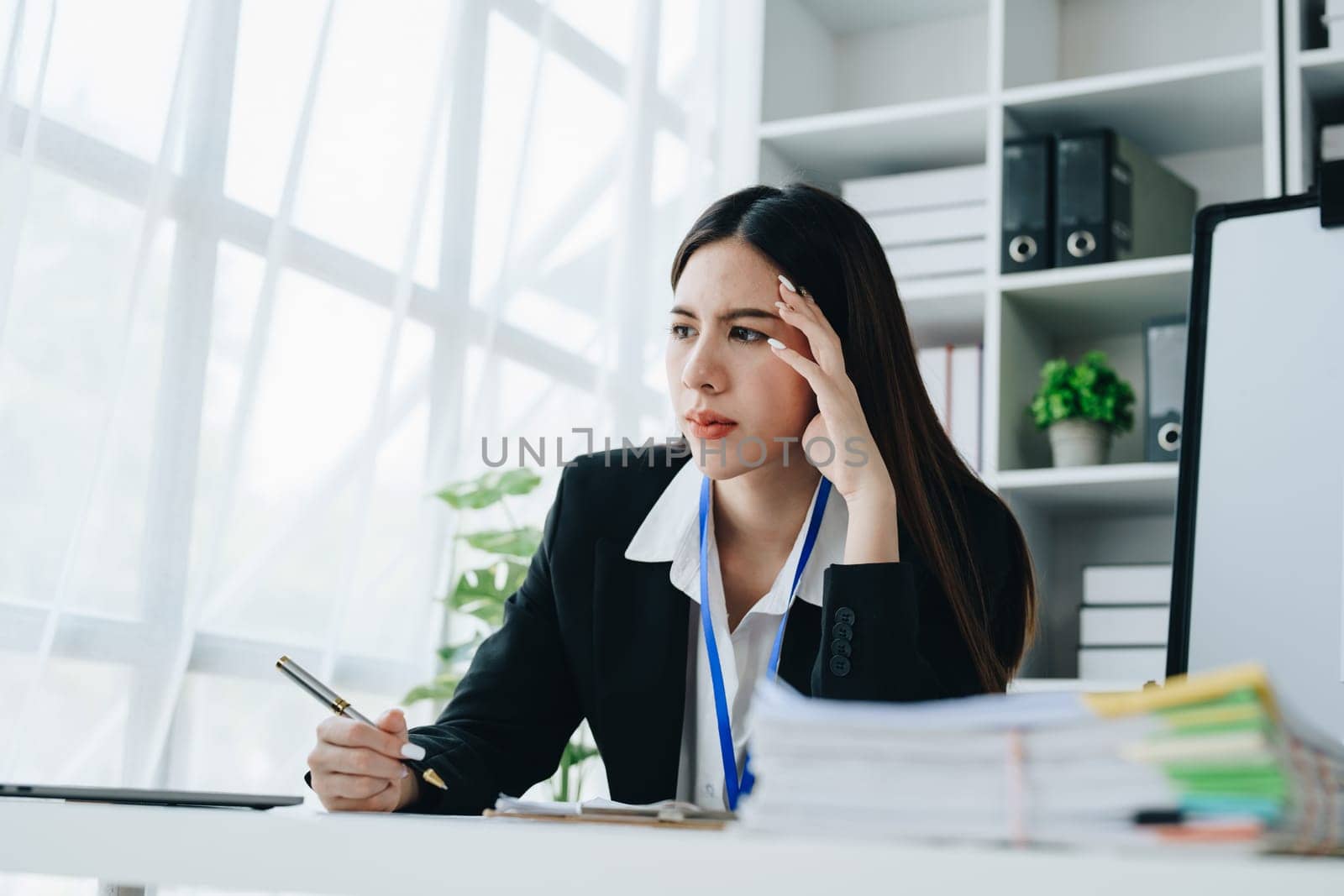 Portrait of business owner, woman using computer and financial statements Anxious expression on expanding the market to increase the ability to invest in business by Manastrong