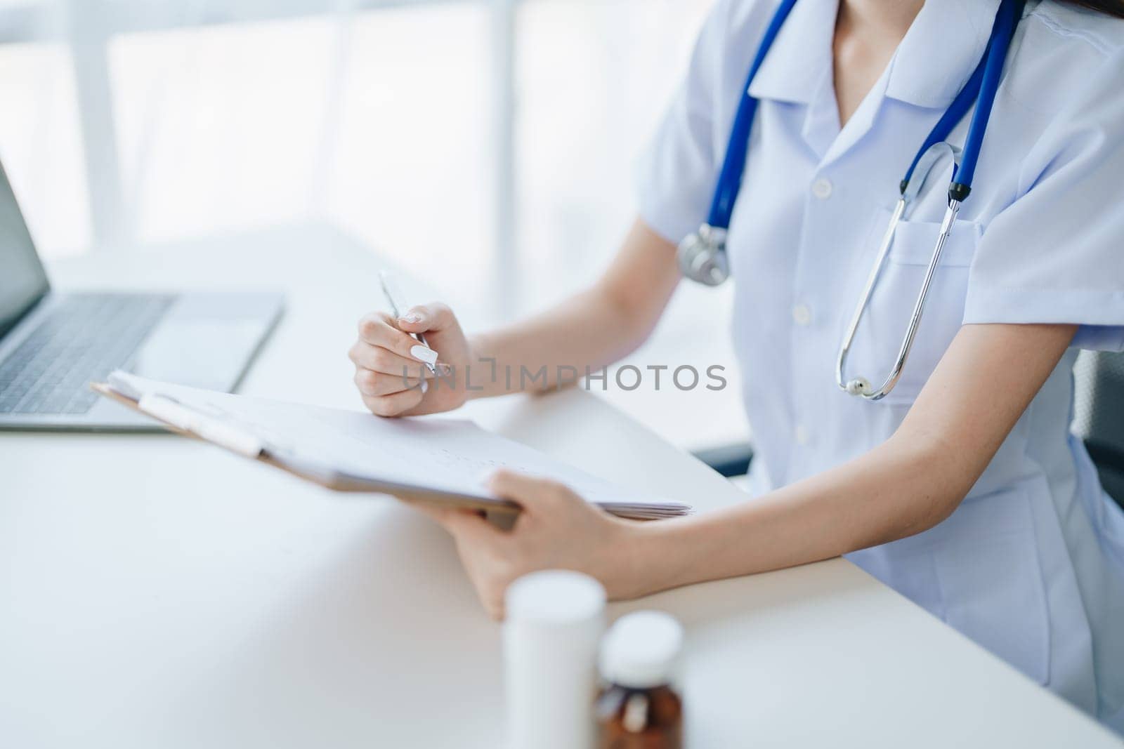 The doctor is checking the patient's history before giving treatment by Manastrong