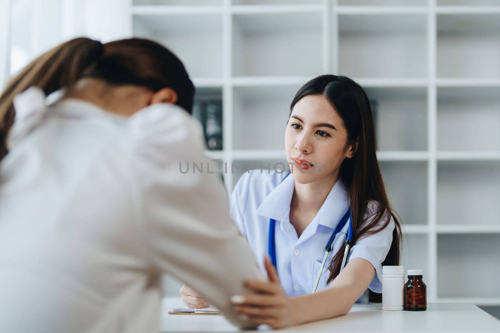 A doctor psychologist is giving counseling to a depressed patient by Manastrong