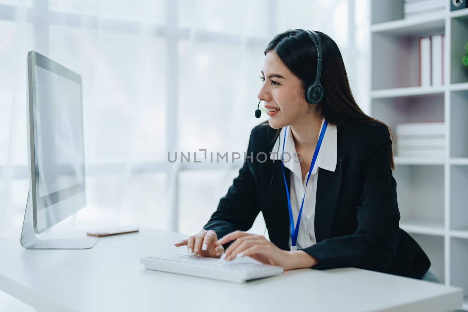 young business woman wear wireless headset video conference calling on laptop computer talk by webcam discussing in online meeting about budget and profit of company by Manastrong