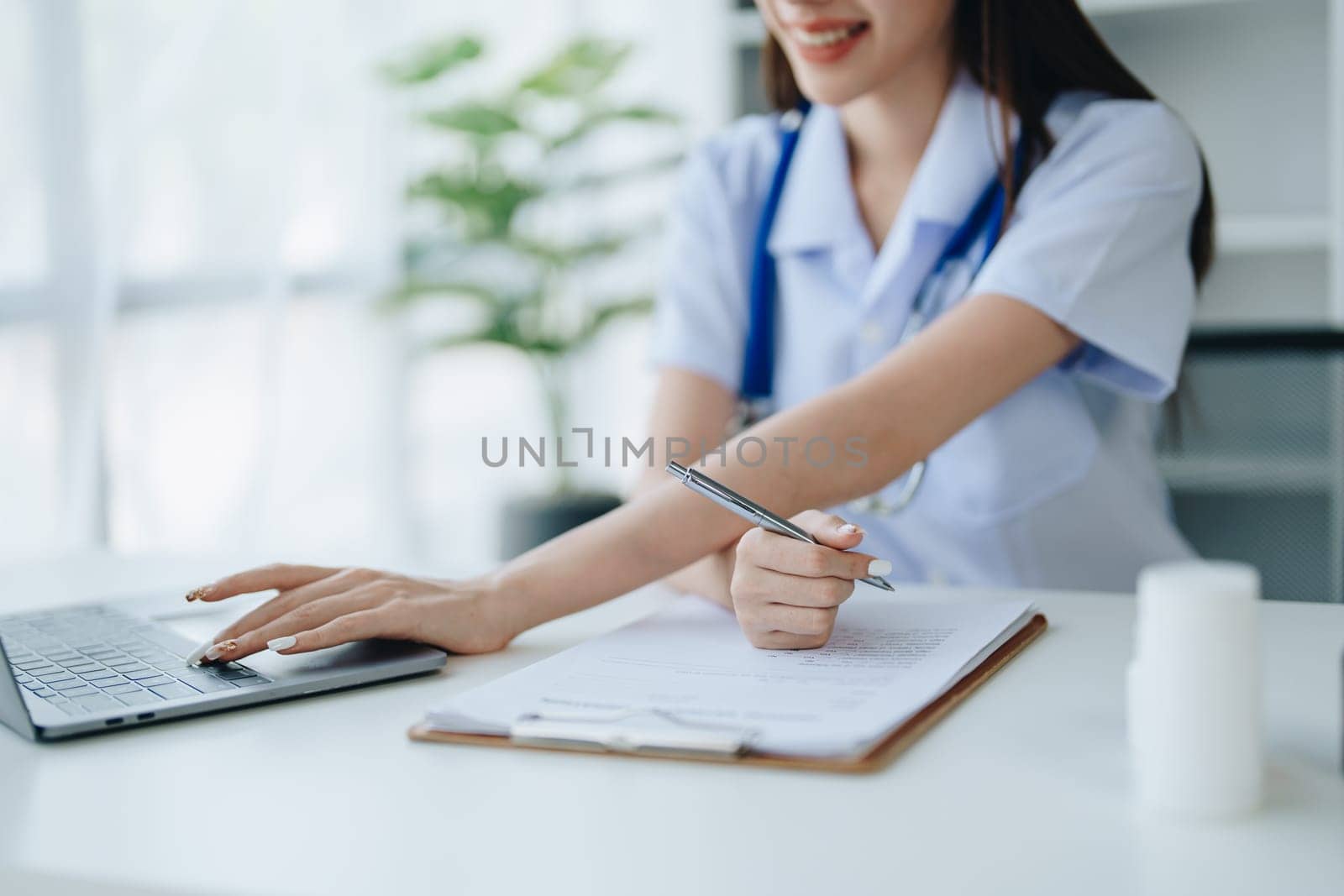 The doctor is checking the patient's history before giving treatment by Manastrong