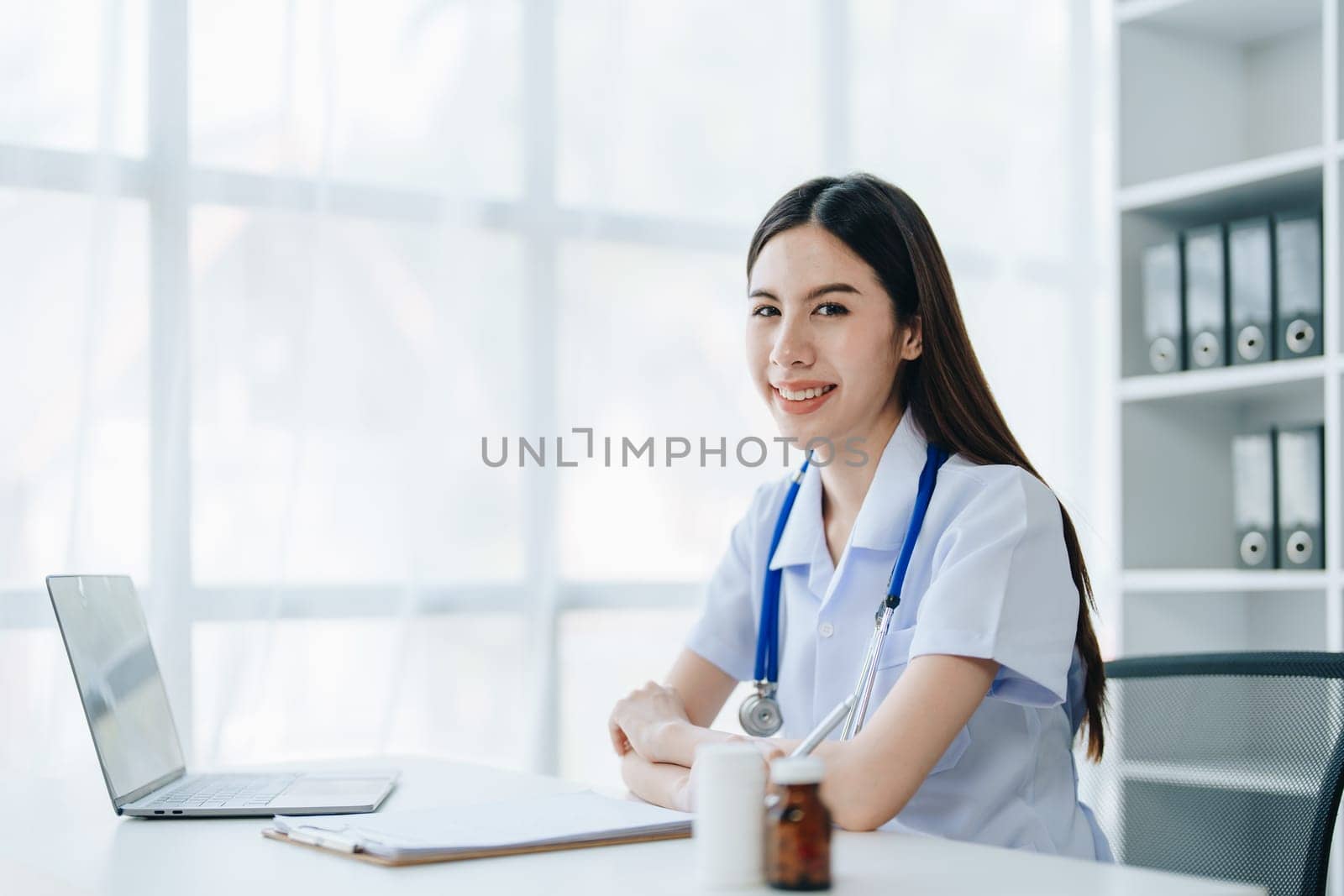 The doctor is checking the patient's history before giving treatment by Manastrong