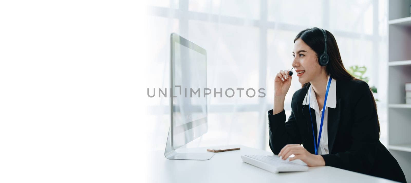 young business woman wear wireless headset video conference calling on laptop computer talk by webcam discussing in online meeting about budget and profit of company. copy space concepts by Manastrong