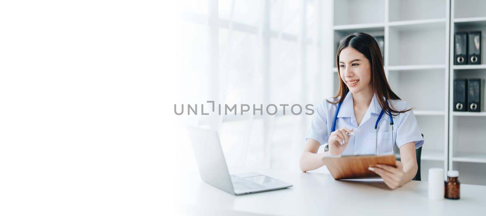 The doctor is checking the patient's history before giving treatment by Manastrong