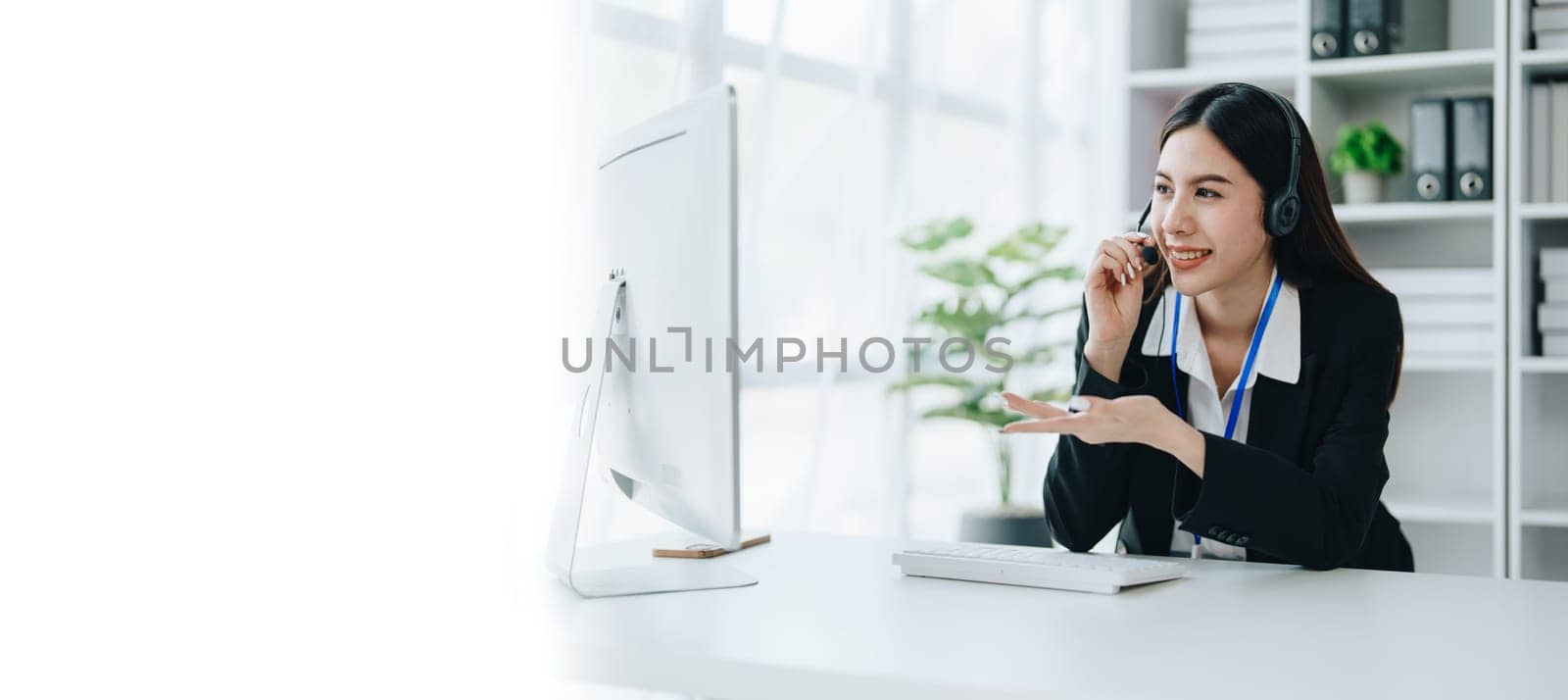 young business woman wear wireless headset video conference calling on laptop computer talk by webcam discussing in online meeting about budget and profit of company. copy space concepts.