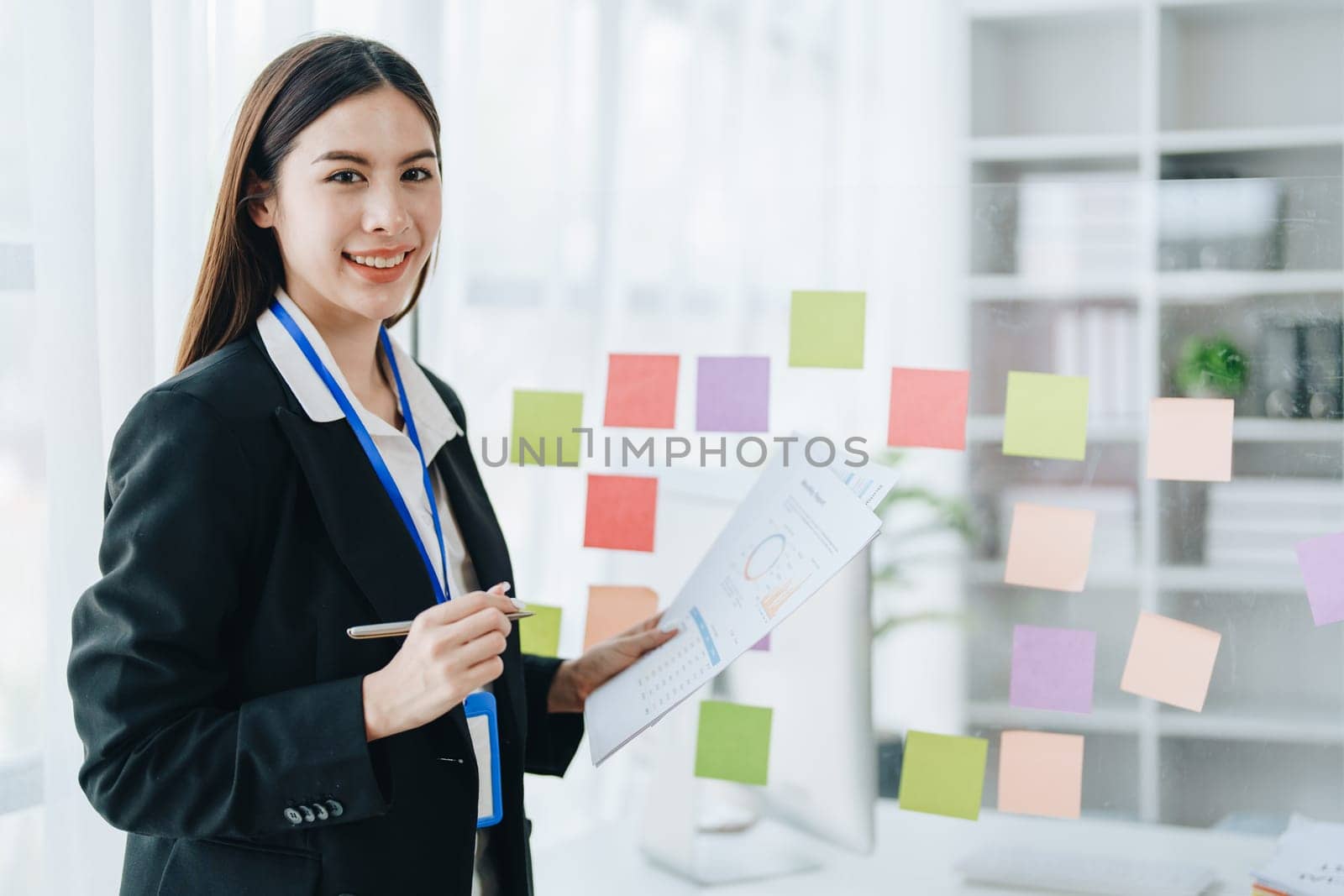Beautiful young teen asian businesswoman using note pad thinking with planning working on financial document, tax, exchange, accounting and Financial advisor.