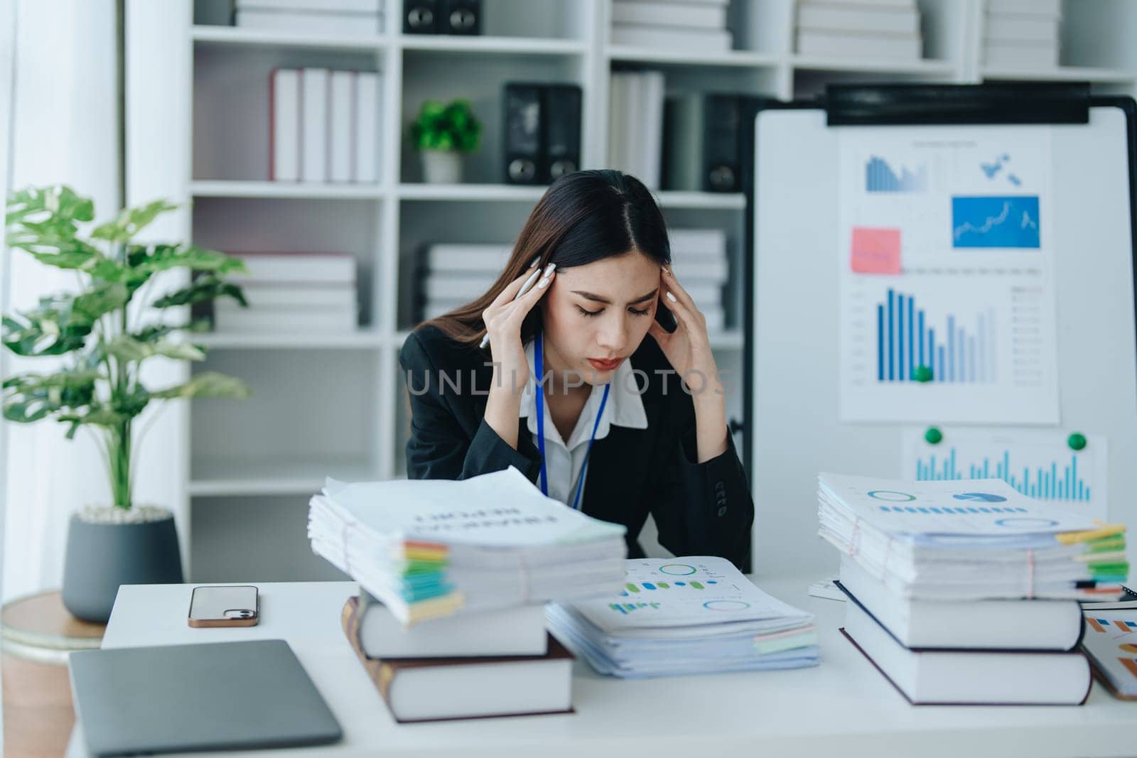 Portrait of business owner, woman using computer and financial statements Anxious expression on expanding the market to increase the ability to invest in business by Manastrong
