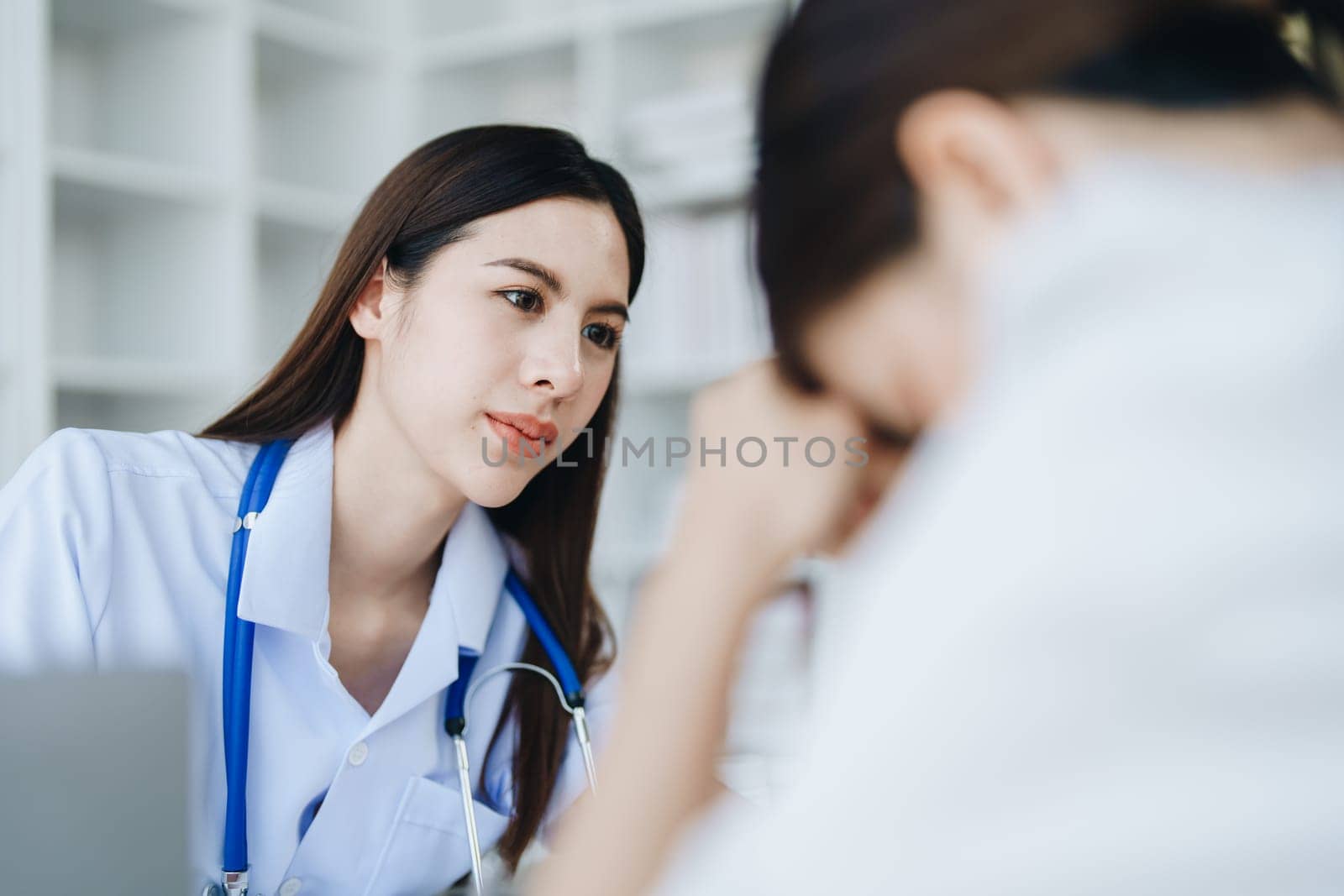 A doctor psychologist is giving counseling to a depressed patient by Manastrong