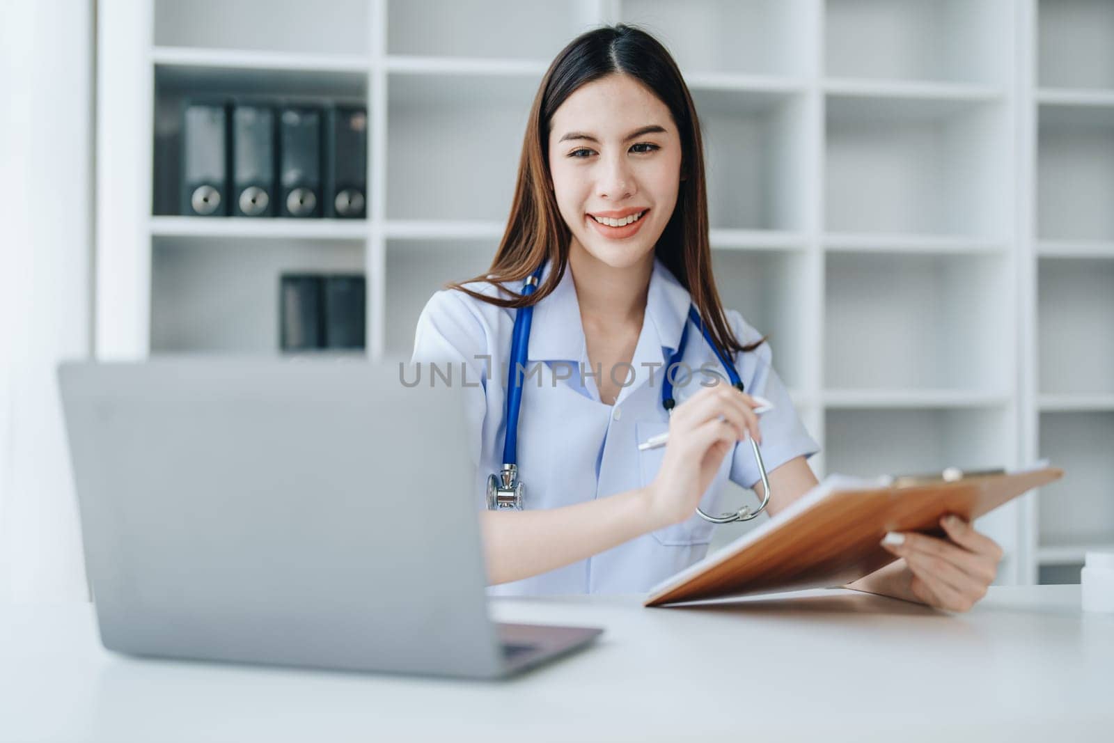 The doctor is checking the patient's history before giving treatment by Manastrong