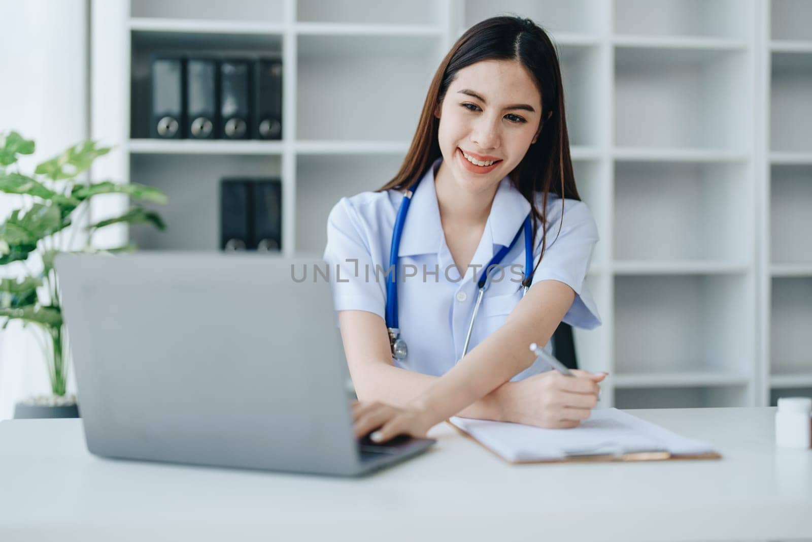 The doctor is checking the patient's history before giving treatment by Manastrong