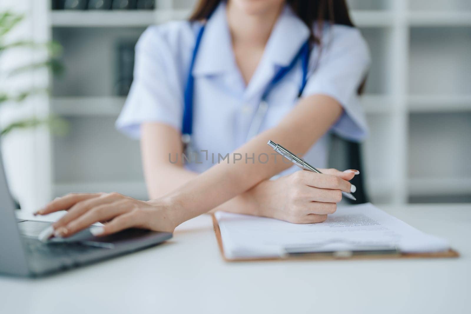 The doctor is checking the patient's history before giving treatment by Manastrong