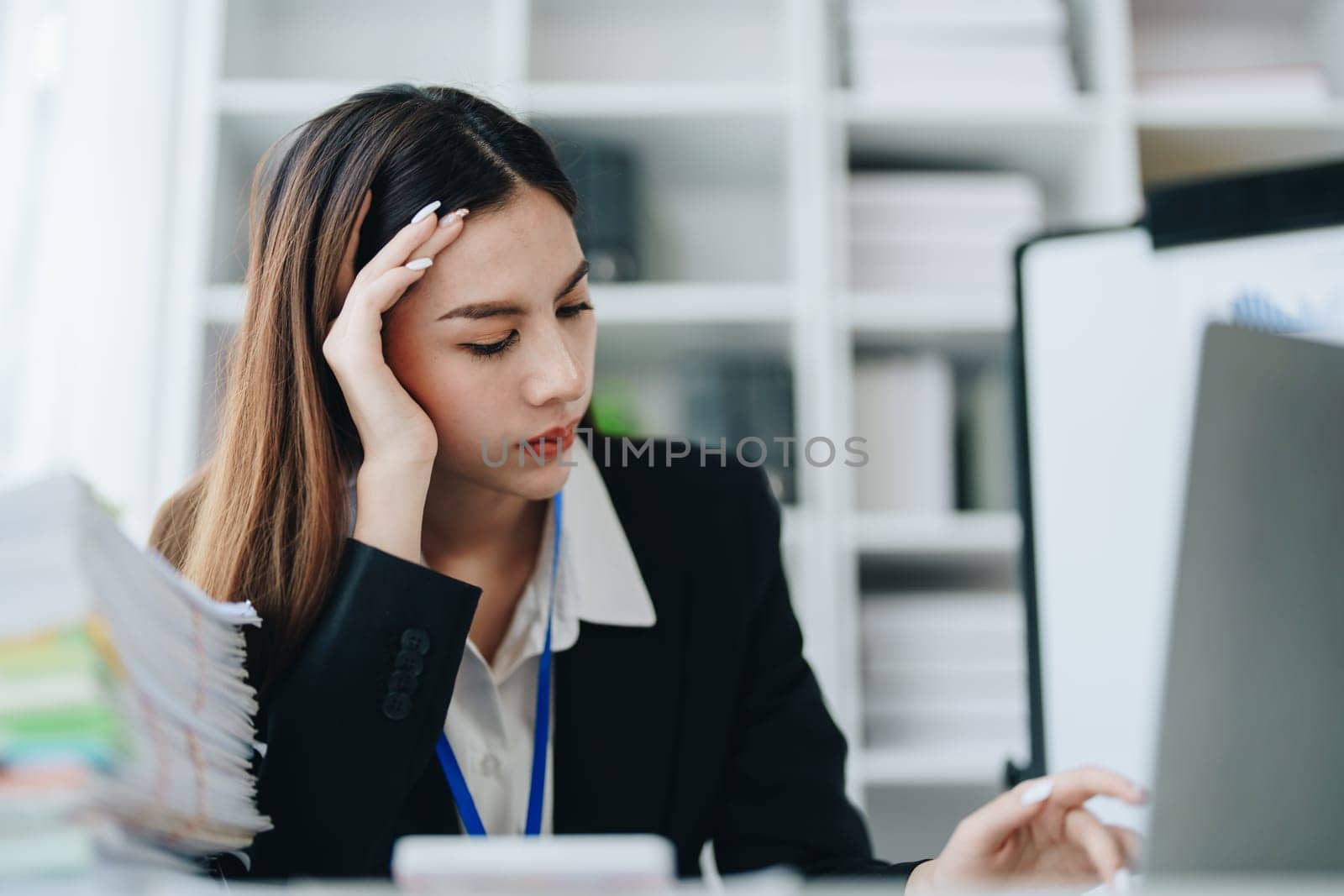 Portrait of business owner, woman using computer and financial statements Anxious expression on expanding the market to increase the ability to invest in business by Manastrong