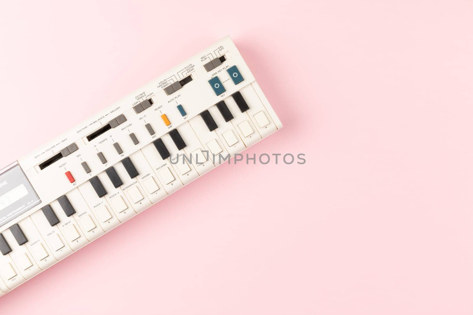 Vintage electronic keyboard synth piano on pink background by TropicalNinjaStudio