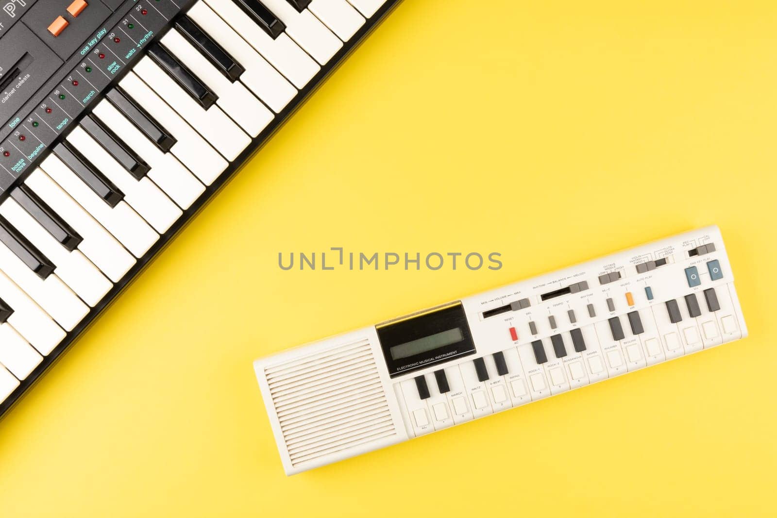 Vintage electronic keyboard synth piano on yellow background by TropicalNinjaStudio