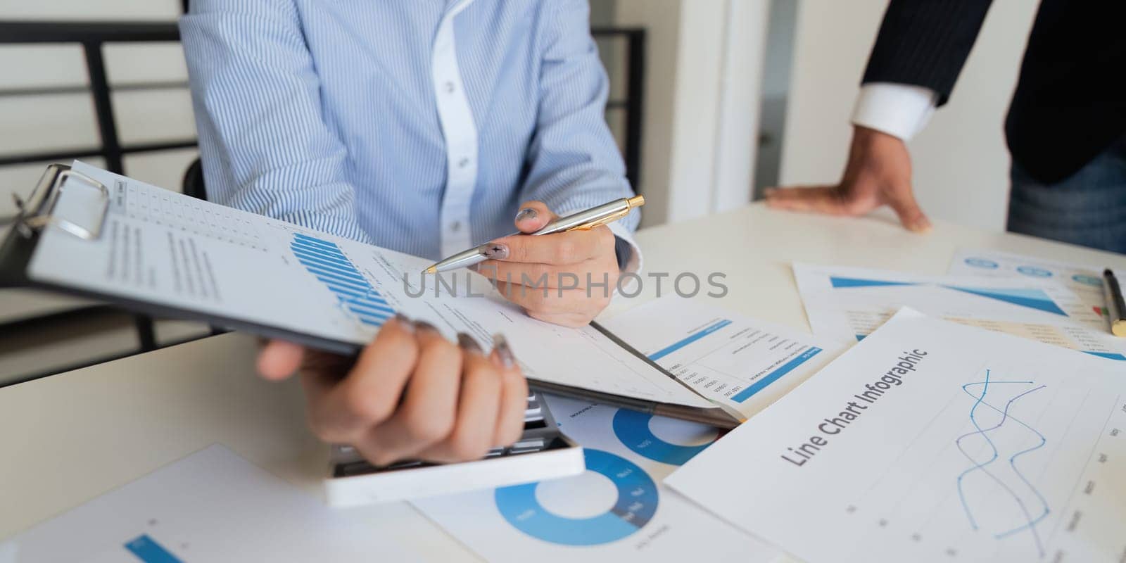 Business team analyzes financial business finance reports on laptop and graph documents during corporate meeting discussion showing successful teamwork, business meeting ideas.