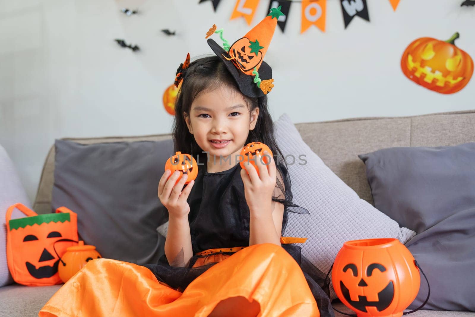 Cute little child girl with balloon. Happy family preparing for Halloween.