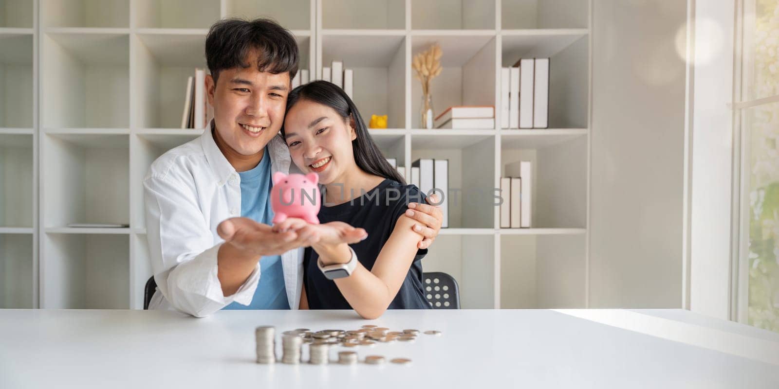 Saving money investment for future. Couple hands holding piggy bank with money . Couple asian counting saving money plan future budget. Investment banking concept by nateemee