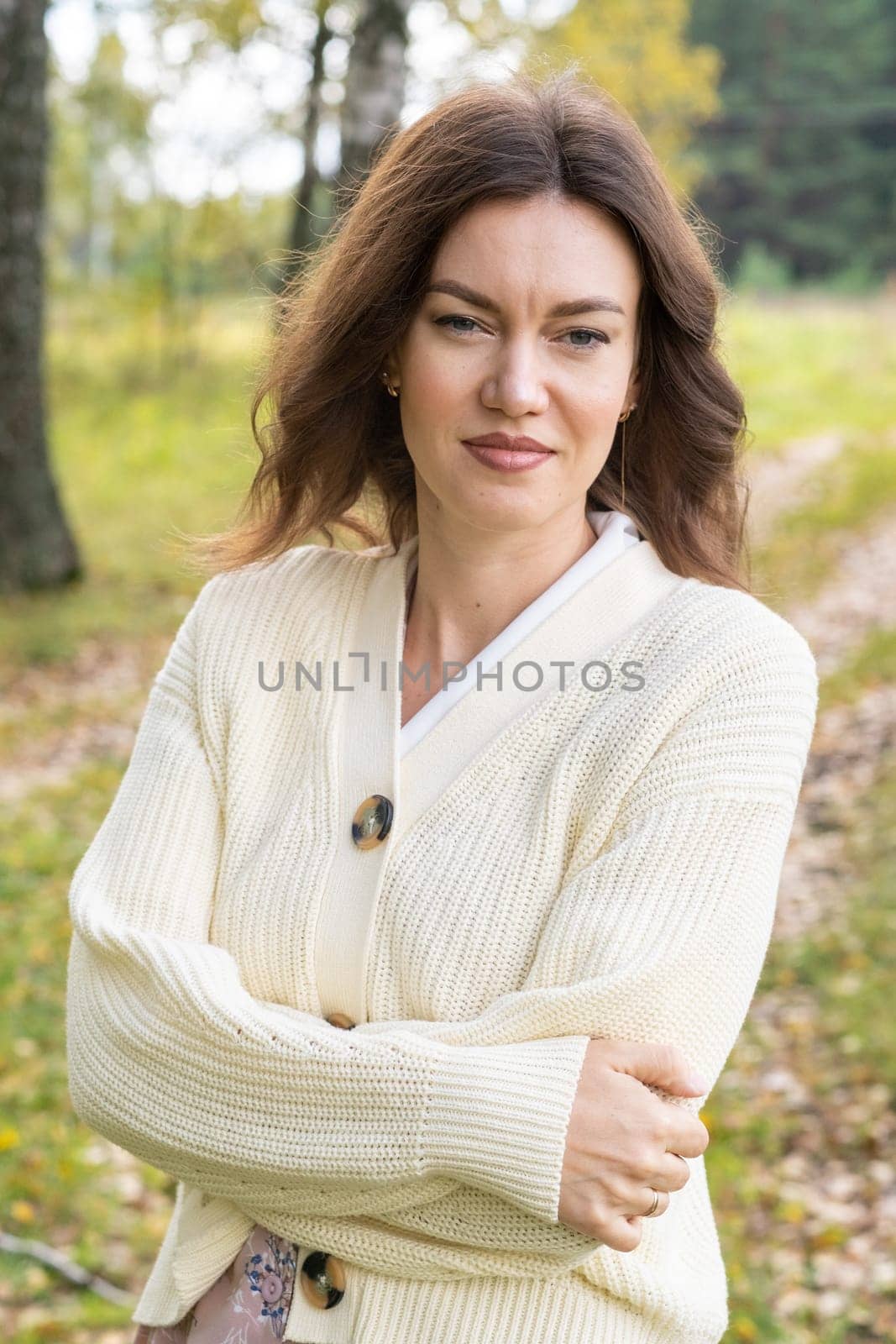 A young beautiful woman in a dress and a round hat reads a book by AnatoliiFoto